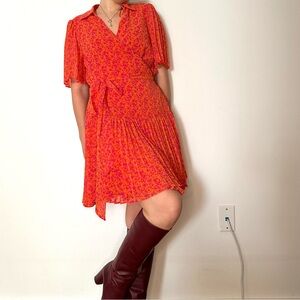 Alexis x Target wrap dress with pleated skirt and sleeves.